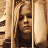 A 48x48 pixel animated contact sheet showing two frames of a buddy icon featuring a person with long hair behind vertical bars on the left and green text reading "Original Icons .com" on a dark green background on the right.