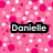 Pixelated pink background with scattered white and light pink squares, featuring a black rectangular banner containing the name 'Danielle' in gray block letters.
