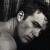 A pixelated grayscale image of a person with dark hair and closed eyes, positioned next to green text reading 'Original Icons .com' on a solid background.