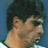 Pixelated static image of a person's head and shoulders with dark hair against a blue background, rendered in low-resolution 256x256 pixels.