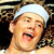 Pixelated static image of a person with light skin wearing a white headband, mouth open in an expressive gesture against a dark background.