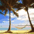 Pixelated beach scene with palm trees, blue sky, and yellow sand; lower section shows water reflections and a heart-shaped text overlay.