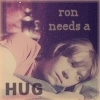 A static image shows a person with light brown hair lying down, wearing a light-colored top, with text reading 'ron needs a HUG' overlaid.