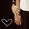 Two hands clasped together on a dark background with a white heart outline drawn below them.