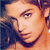 Pixelated close-up of a person's face with light skin tone, dark hair, and a dark garment visible on the left side.