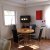 Static pixelated image of a room interior with a desk, chair, monitor, and window.