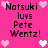 Pixelated text on a bright pink background with scattered heart symbols, showing repeated phrases and alternating heart colors.
