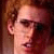 Static image with red pixelated symbols and text on white background, featuring a partial portrait of a person with curly hair.