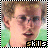 Pixelated image of a person with light brown hair and glasses, wearing a white shirt against a green background, with the word 'skills' in stylized text at bottom.