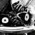 Black-and-white image of a Converse All Star shoe with a pink heart icon, transitioning to a color view of legs wearing pink shoes and gray pants.