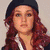 Four pixelated views of a person with long red hair in different poses and accessories.