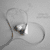 A static image of a lightbulb with smoke, surrounded by heart outlines on a gray background.