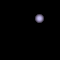 Black background with scattered light purple dots and a small pixelated image of a person's face in the bottom right corner.