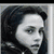 A composite image with four quadrants showing a grayscale portrait, red plus sign, color portrait, and kissing couple.