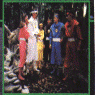 Animated sequence showing multiple characters in colorful costumes across different scenes including forest, indoor, and group settings.