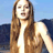 Static 48x48 pixel icon showing a woman with long brown hair in a white top against blue background, low-resolution and pixelated rendering.