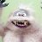 Pixelated image of a cartoonish figure with a wide open mouth, dark eyes, and a light-colored body against a pale green background.