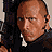 Pixelated image of a bald man holding a large firearm, with partial views of his arm and weapon in adjacent frames.