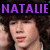 Pixelated image of a person with dark hair and closed eyes, overlaid by large purple text reading 'NATALIE' on a black background.