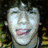 Four distinct facial expressions of a person with dark curly hair in a , each showing different poses and clothing