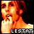 Pixelated image of a person with fiery orange and red hair, holding a white candle against dark background, with 'LESTAT' text at bottom.