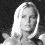 A black-and-white image of a woman with long blonde hair in three , below which blue text reads "BLUE CRUSH" and "KATE BOSWORTH"