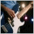Pixelated image of a white electric guitar with brown neck and headstock, held against dark background with blue and purple highlights.