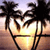 A static pixelated image shows a heart-shaped arrangement of palm trees against a sunset sky with warm orange and yellow tones.