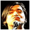 A person with shoulder-length brown hair sings into a microphone, with text and heart symbols appearing in different frames.