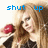 A pixelated image of a person with long brown hair holding red objects, featuring blue text above the head.