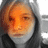 A pixelated image of a person with light brown hair wearing a dark hooded garment, showing two states: one without text and another with "Im erin" overlaid in black block letters.