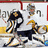 Pixelated static image of two hockey players in action on an ice rink, one player wearing a dark jersey with yellow accents and the other in white.