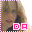 A pixelated image of a person with light brown hair and dark eyes, wearing a black top against a gray background.