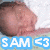 A pixelated image of a person's head with closed eyes and a slight smile, accompanied by text reading "SAM <3" in blue and green backgrounds.
