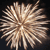 A static pixelated image of a radial burst with light brown and beige tones against a dark background, resembling a stylized explosion or firework.