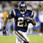 Pixelated football player in blue jersey with number 27 running on field, surrounded by blue background with white text reading HE COULD GO ALL THE WAY.
