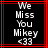 Black background with red border, white pixelated text reading 'We Miss You Mikey <33' in vertical alignment