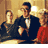 Static 48x48 pixel icon depicting three figures in formal attire against a warm-toned background with visible dithering and low-resolution rendering artifacts.