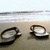 Two circular icons on a beige background with white and gray horizontal stripes at the top; one icon is dark brown, the other light gray.