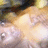 Pixelated image with warm-toned abstract shapes and light gradients, no discernible subjects or text.