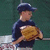 A child in a dark blue shirt and cap holds a brown baseball glove against a green background, with subtle pose variations across frames.