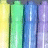 Pixelated vertical bars in yellow, green, blue, purple hues with black pixel-art text reading "it doesnt matter what color u are cuz were all the same".