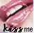 Pixelated image of lips with a dark object against pink and white background, text 'kiss me' at bottom.