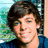 A pixelated image of a person with brown hair and blue eyes, wearing a dark blue shirt against an outdoor background.