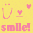 Pixelated yellow background with pink text and symbols: a smiling face, two hearts, and the word 'smile!' in lowercase.