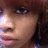 A pixelated close-up of a person with brown hair and blue eyes, showing subtle facial expression changes