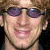 A 2x2 contact sheet of four animated frames showing a pixelated image of a person with sunglasses and text elements in various styles across the grid.