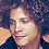 Two side-by-side pixelated portraits of individuals with curly hair above a yellow displaying text and abstract shapes