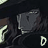 Pixelated dark-toned icon with a central gray rectangular shape, light-colored curved elements on left and right edges, and a small white 'D' symbol in bottom-right corner.