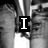 Black-and-white pixelated image with text overlays reading "I love brian" over a background of repeated figures in motion.